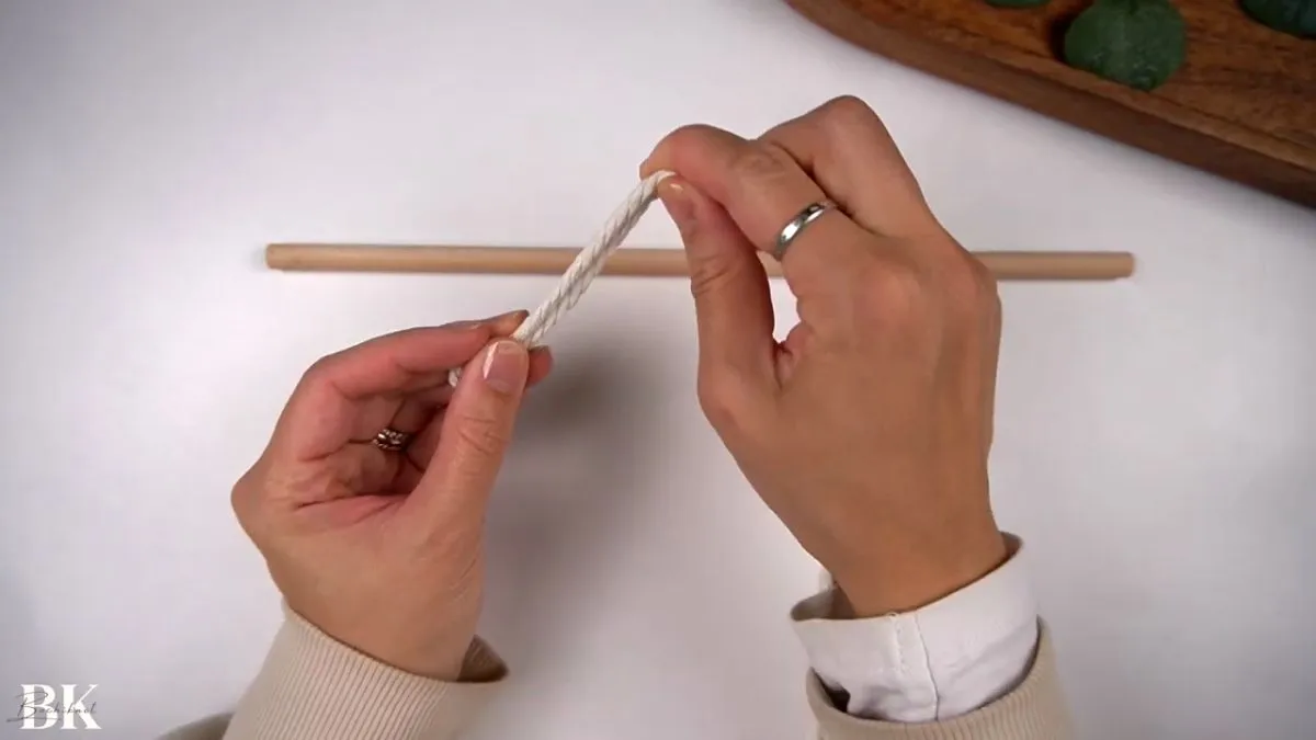Attaching macrame cord to wooden dowel using a lark's head knot