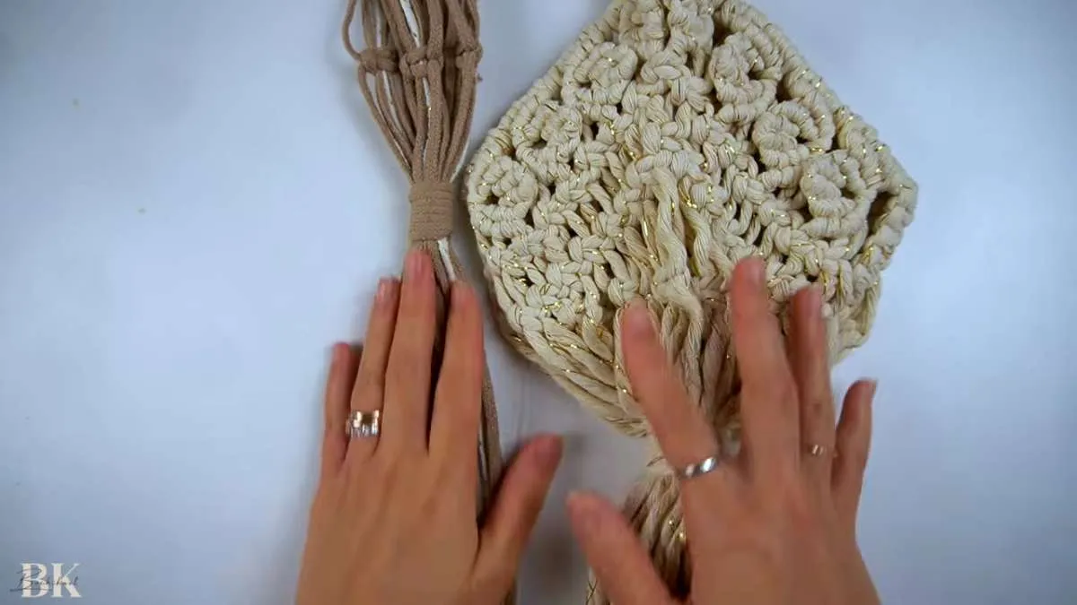 Close-up of an intricate macrame plant hanger basket section showing dense knotwork