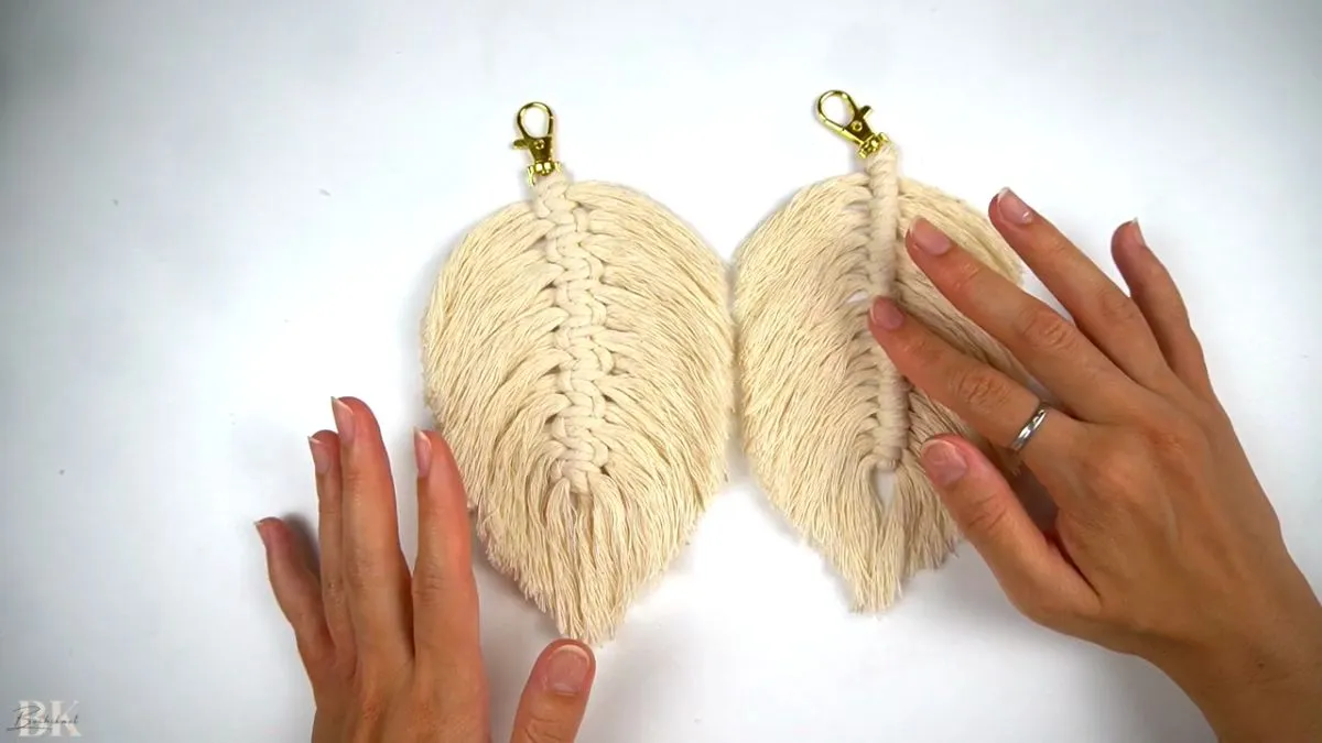 Two completed macrame feathers side by side showing the double half hitch and square knot patterns