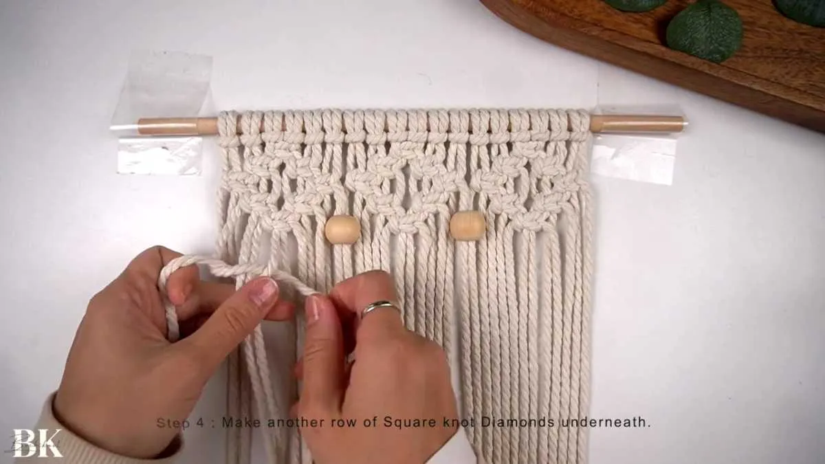 Starting the second row of square knot diamonds below the beads