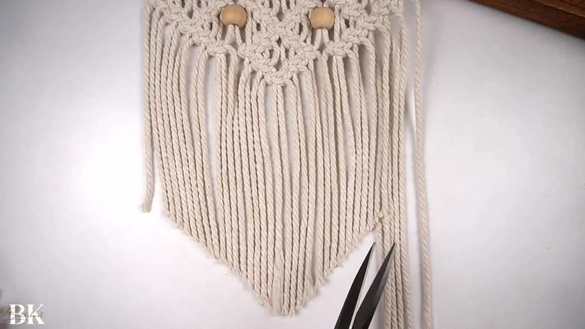 Completed V-shaped fringe on the macrame wall hanging ready for display