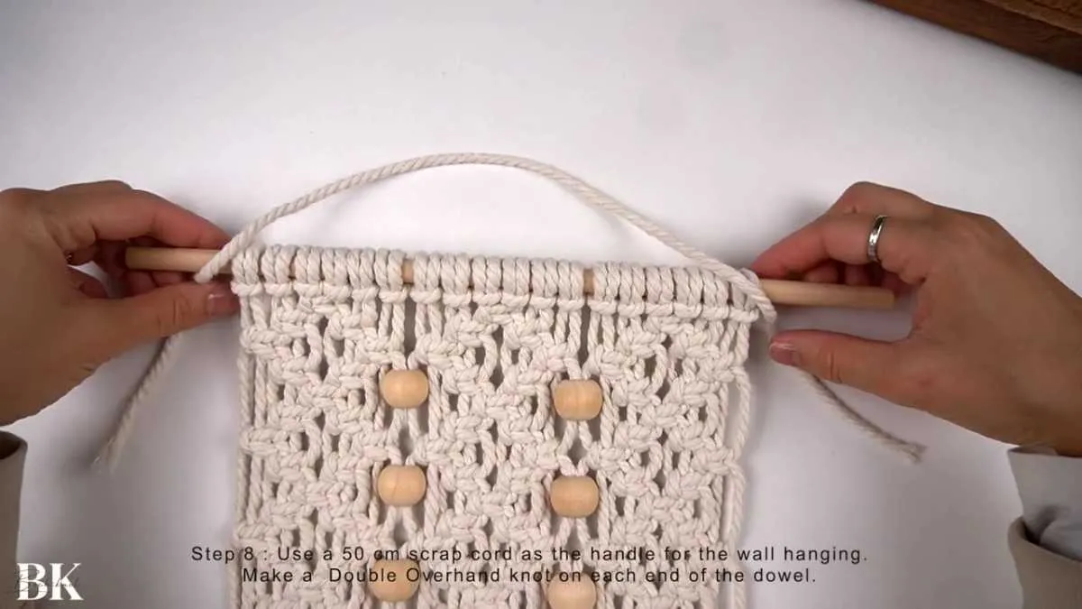 Attaching the macrame cord handle to the wooden dowel with double overhand knots